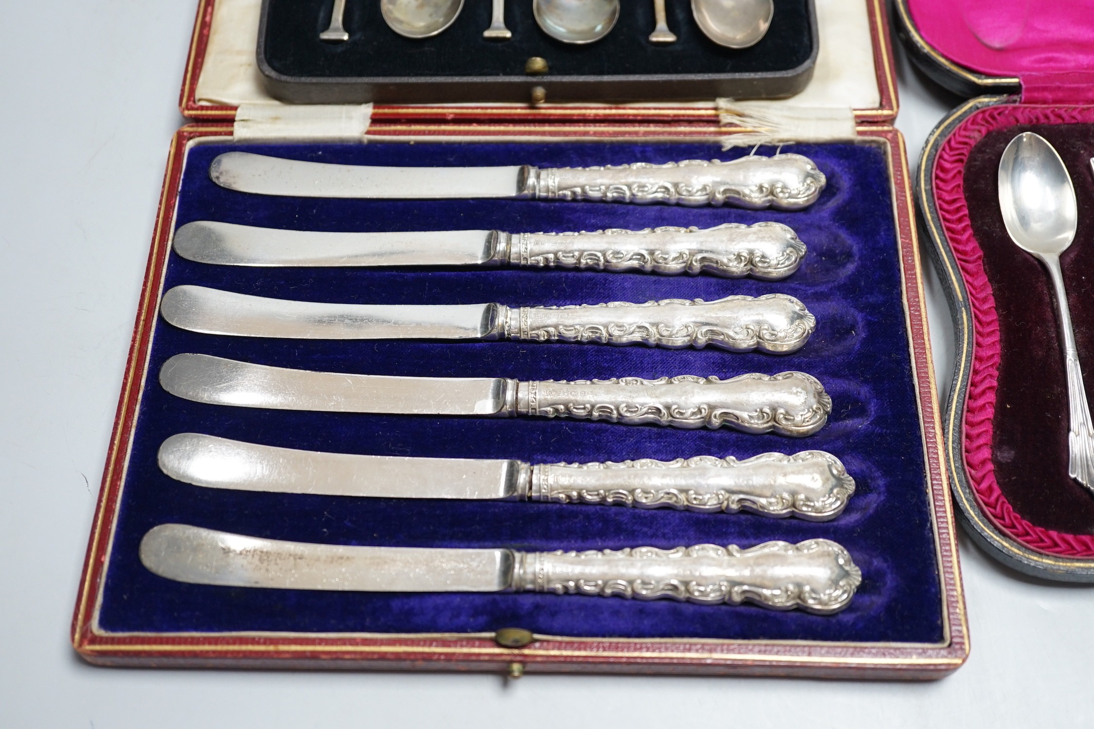 A set of six teaspoons, London, 1910, a set of six silver coffee spoons, six silver handled tea knives, all cased.